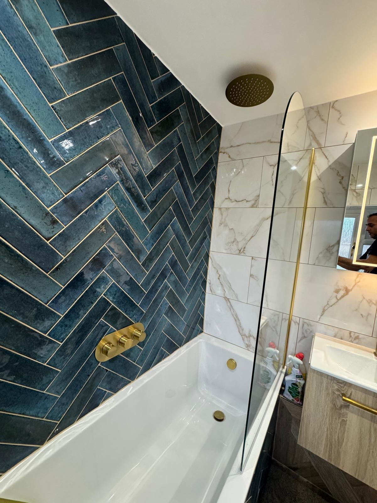 A luxury bathroom with teal tiling and gold fittings by Professional Polish Builders in Croydon & South London