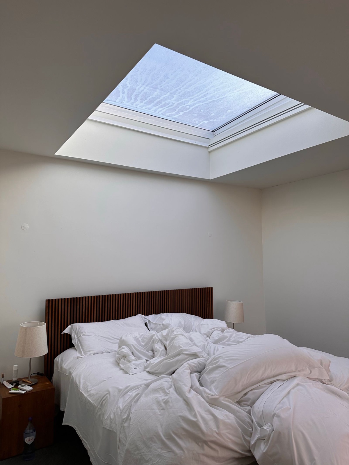 A white loft conversion bedroom with a skylight by Professional Polish Builders in Croydon & South London