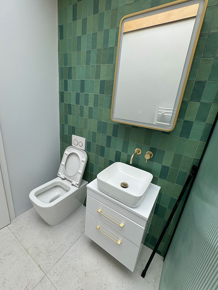 An emerald-tiled bathroom by Professional Polish Builders in Croydon & South London